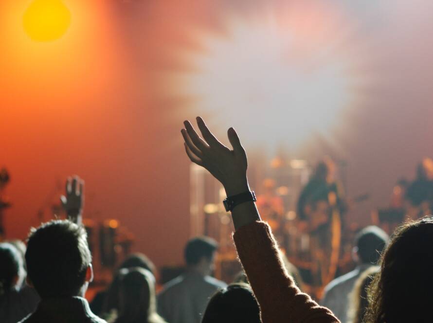 Hands raised in worship session